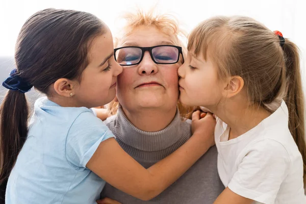 Elderly woman with her little granddaughters — Stock Photo, Image