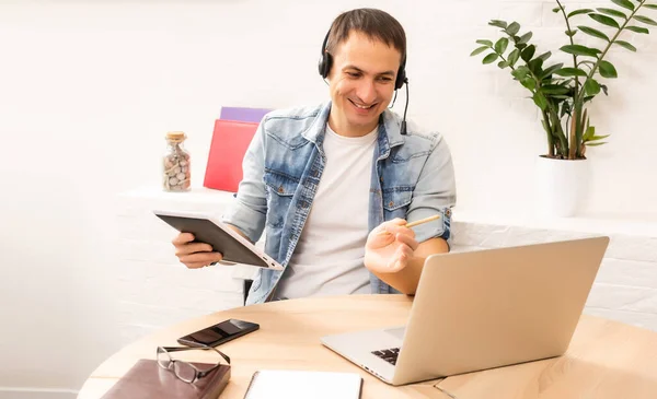 Handsome young man online using a laptop — Stock Photo, Image