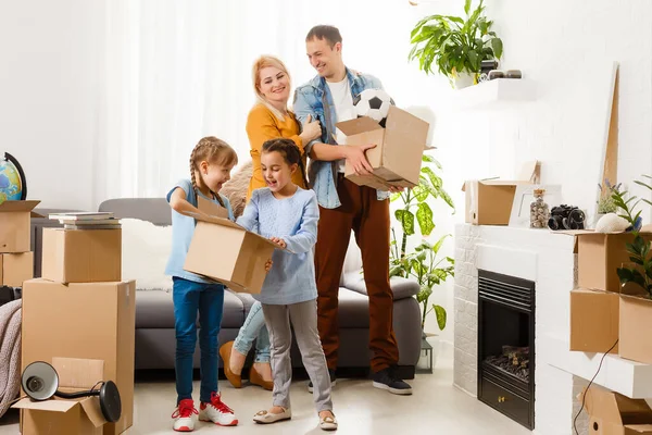 Family with cardboard boxes standing in row at home — Stock Photo, Image