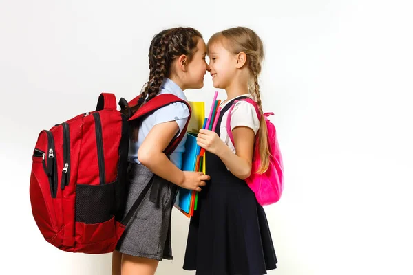 Two young girls whispering and sharing a secret during class in school — Stock Photo, Image