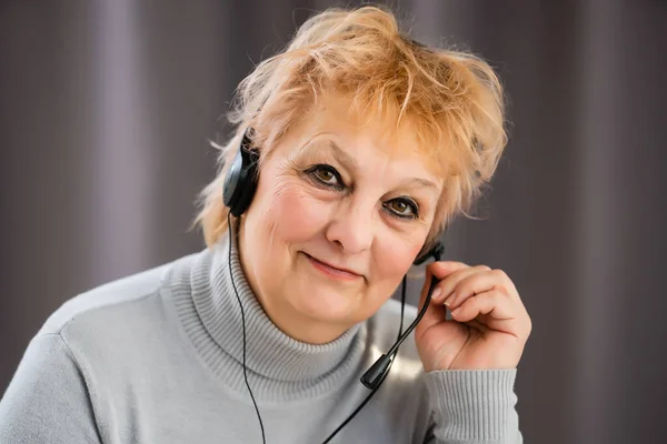 Head shot mature woman looking at camera and talking, grandmother chatting with relative online, making video call, middle aged blogger recording vlog, teacher speaking to webcam, distance lecture