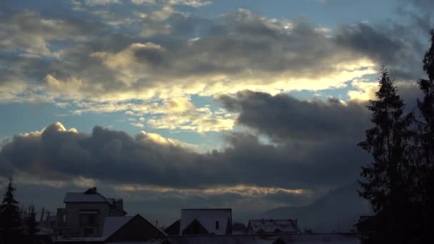 Winter sky over rooftops and treetops — Stock Video