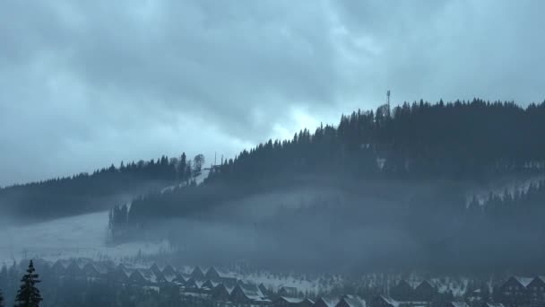 Typical mountain village lost in the middle of the blanket of white snow on a cold winter day — Stock Video