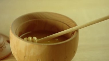 Tahta bir kasede ahşap bir masada bal.