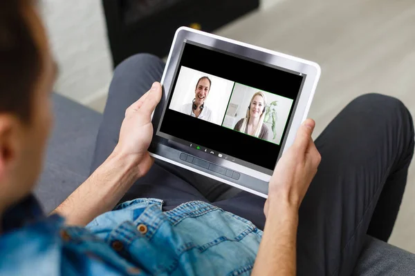 Homme ayant une vidéoconférence avec des amis sur ordinateur portable à la maison — Photo
