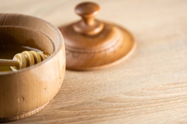 Tahta bir kasede ahşap bir masada bal.