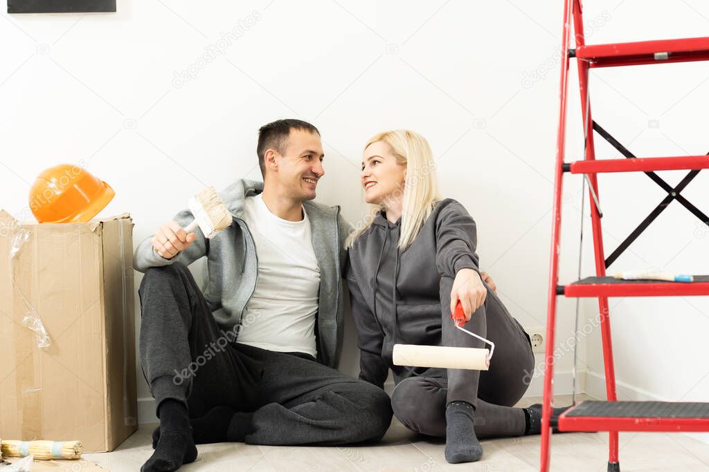 Couple redecorating home, couple makes repairs in the apartment