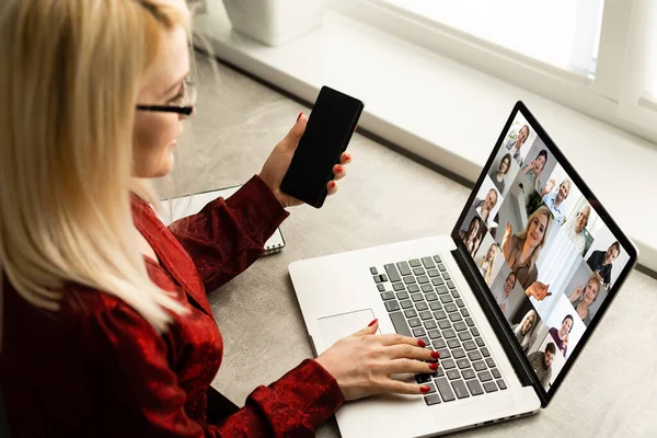 Mujer y el equipo en la pantalla del ordenador portátil hablando y discutiendo en videoconferencia. Trabajar desde casa, Trabajar a distancia, Autoaislamiento. — Foto de Stock