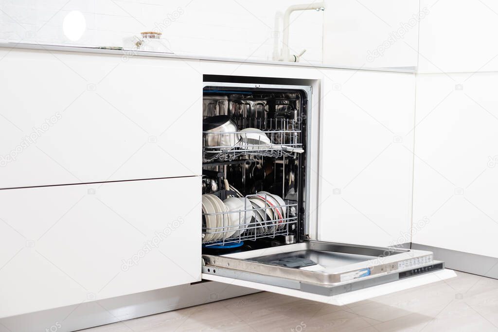 Picture of an opened dishwasher in the kitchen