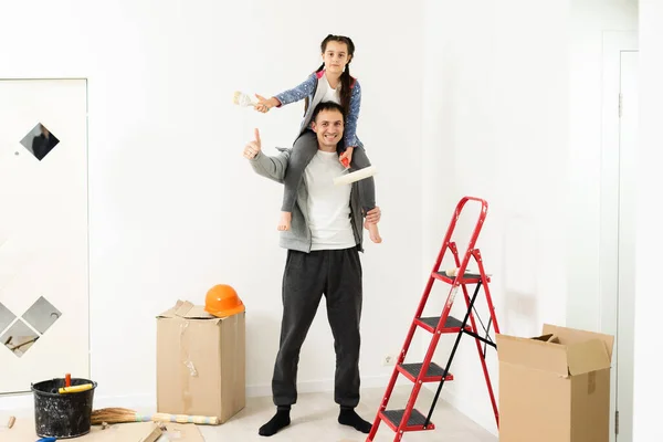 Familia, hija feliz con papá haciendo reparación de la casa, paredes de pintura, junto con el amor — Foto de Stock