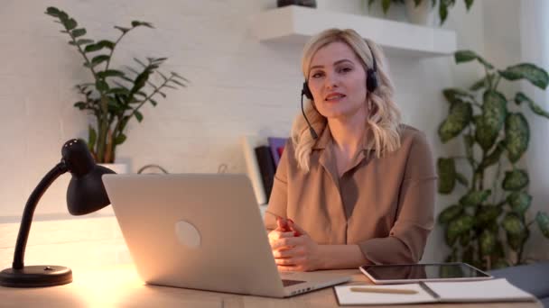 A happy woman girl works remotely from home and communicates via video call with friends and relatives in her office. Distance learning and work online. Using computer. — Stock Video