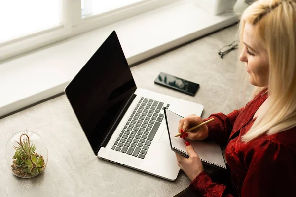 Красива молода жінка працює на ноутбуці в її офісі . — стокове фото