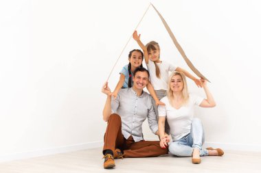 Genç bir aileyi barındıran konsept. Anne, baba ve çocuklar çatılı yeni evdeler.