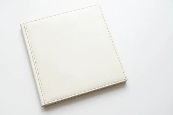 The book with a white cover on white background