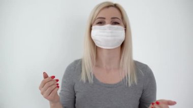 İş görüşmesi. Kameraya konuşan genç bir kadının portresi. Kapalı alanda maske takıyor..