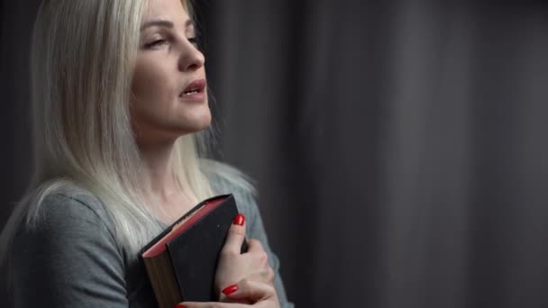 Closeup portrait of a young woman praying — Stock Video