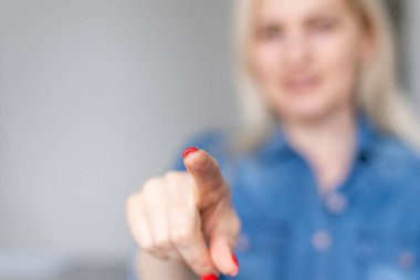 Kadın parmaklarıyla hayali ekrana dokunuyor.