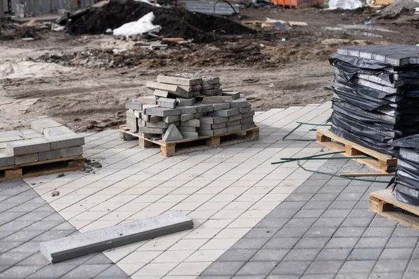 Repair of the sidewalk. Worker stonemason repair the sidewalk for Laying paving slab