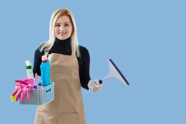 Young smiling cleaner woman. Isolated over blue background — Stock Photo, Image