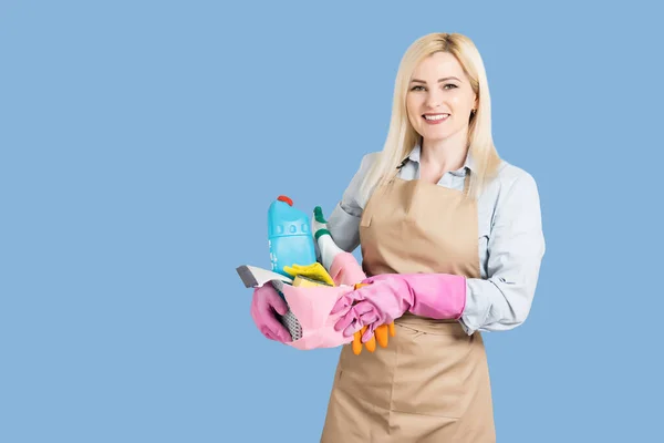 Young smiling cleaner woman. Isolated over blue background — Stock Photo, Image