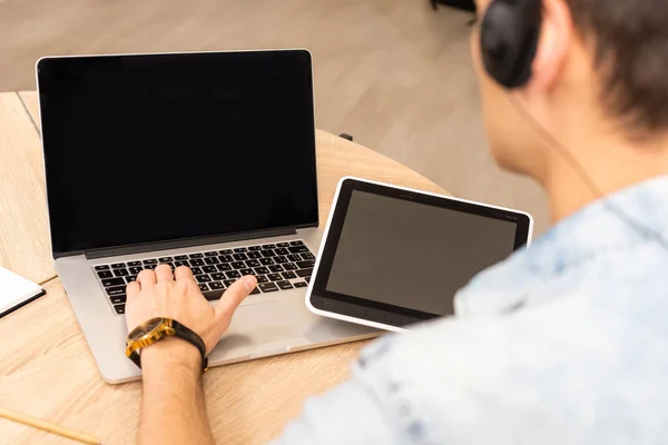 technology, remote job and lifestyle concept - happy man with laptop computer having video chat and waving hand at home office