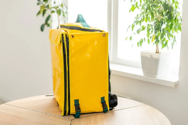 Closeup of delivery backpack, yellow food delivery bag