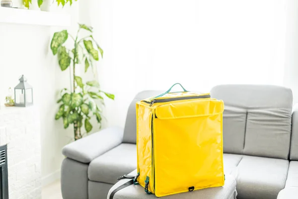 Closeup of delivery backpack, yellow food delivery bag