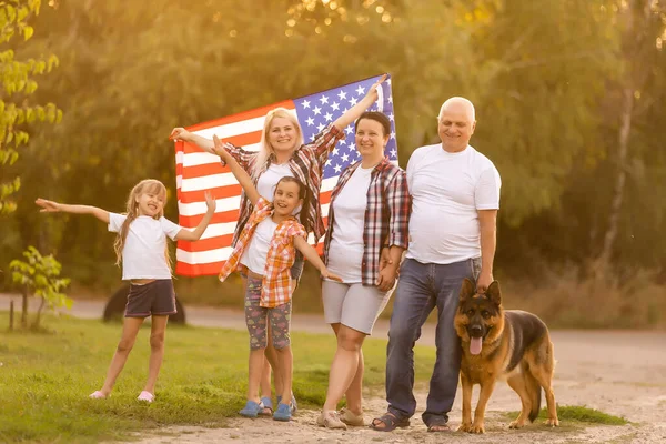 Family Posing Outdoors With American Flag — Stock Photo, Image
