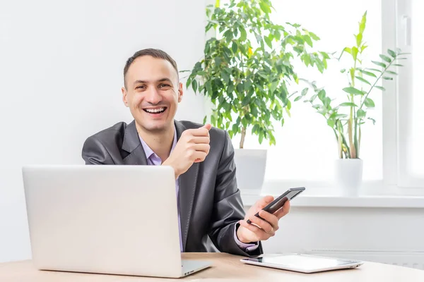 Handsome businessman working with laptop in office — Stock Photo, Image