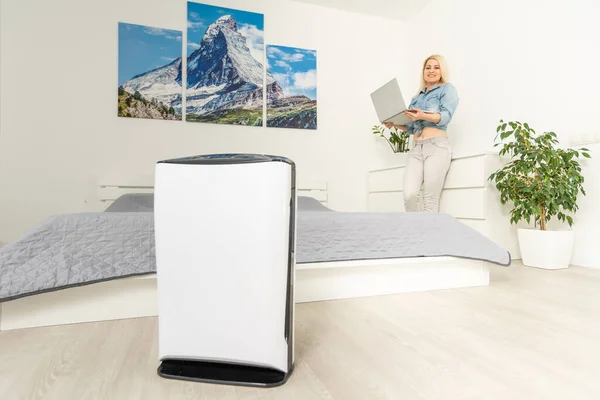 Modern air humidifier and blurred woman resting on background — Stock Photo, Image