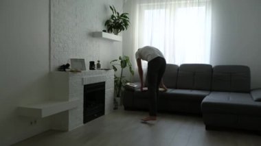 Adam beyaz bir duvara tuval resmi asıyor. Yaratıcı atölye