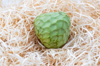 Saman arka planında muhallebi elması ya da Cherimoya. egzotik meyveler.