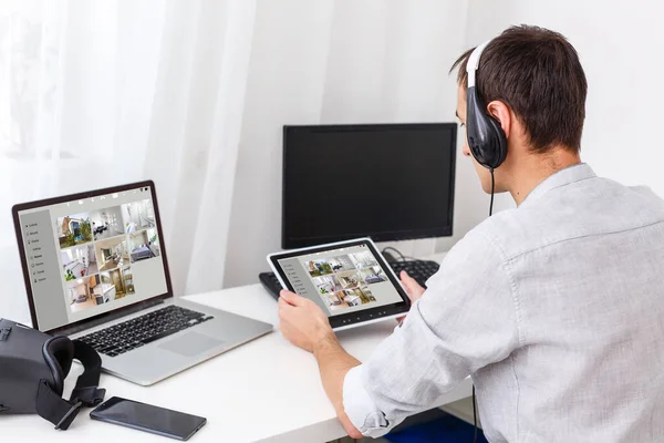 man having Home automation control station in a modern home 3D render