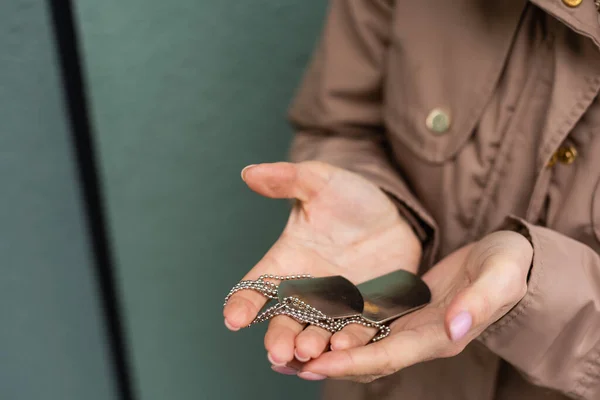 Woman holding in hand military token — Stock Photo, Image