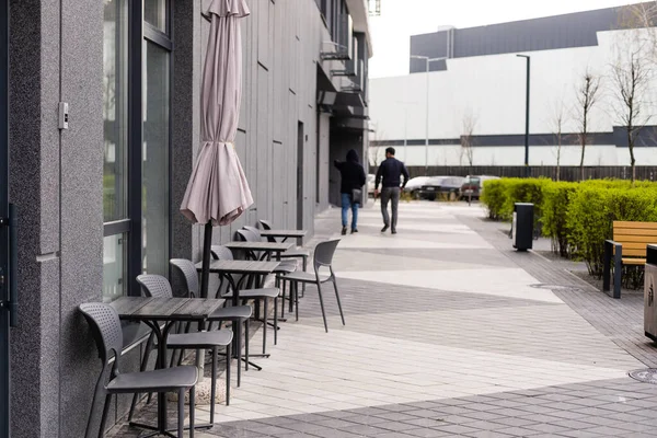 La foto muestra una mesa y sillas en una terraza abierta cerca de la cafetería — Foto de Stock