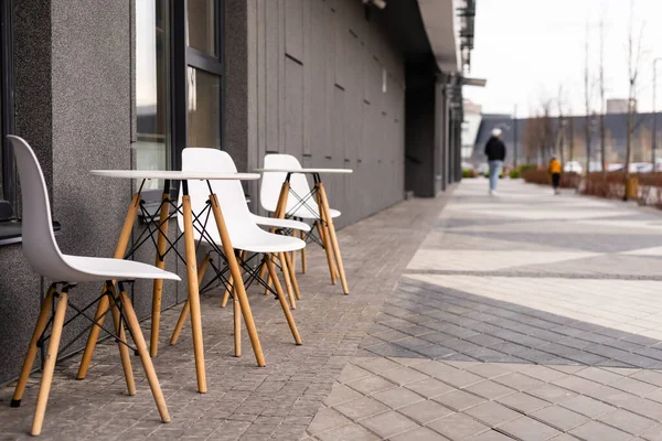 La foto muestra una mesa y sillas en una terraza abierta cerca de la cafetería —  Fotos de Stock