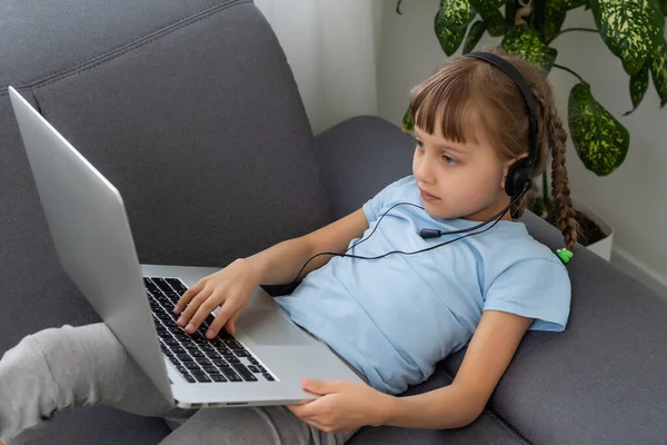 Domácí školka malá mladá dívka student učení virtuální internet on-line třídy ze školy učitel na dálku setkání kvůli covid pandemie. Žena výuka matematiky pomocí sluchátka. — Stock fotografie