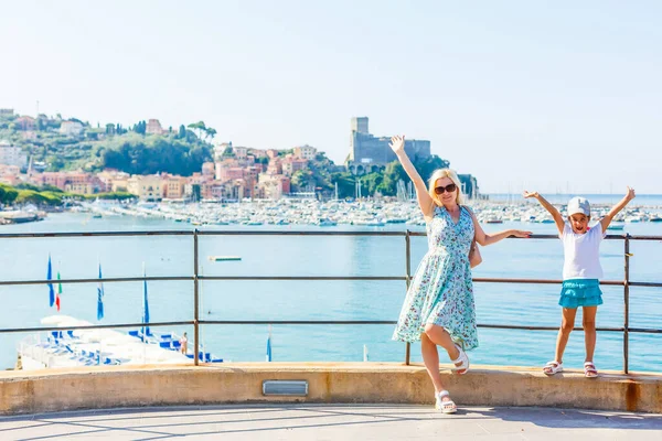 Mutter und Tochter am Gardasee mit Bergen, See und Stadt im Hintergrund. Der Gardasee ist der größte See Italiens. Lifestyle, Urlaub und Reisekonzept. — Stockfoto
