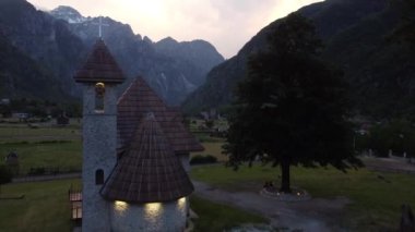 Arnavutluk 'un Theth kentindeki Alp köyü. Geleneksel kilise misafir evleri ve dağlarla çevrili.