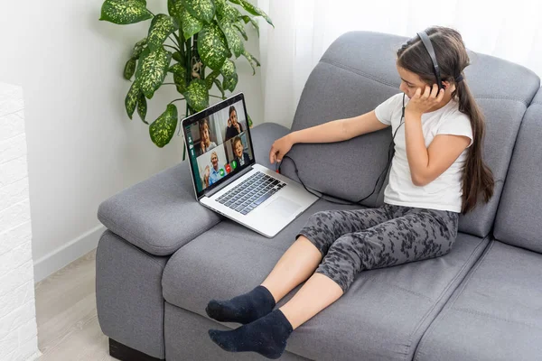 Back view of young girl sit at home, talk have online video call lesson with teacher or tutor, teenage schoolgirl engaged in webcam conversation, study far use web conference app on laptop — Stock fotografie