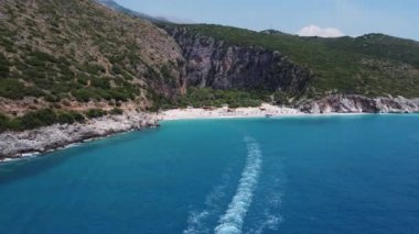 Mavi berrak sularda bir teknenin drone görüntüsü. Mavi denize giden beyaz bir teknenin üst görüntüsü. Büyük sürat teknesi yüksek hızda hareket ediyor. Seyahat - resim