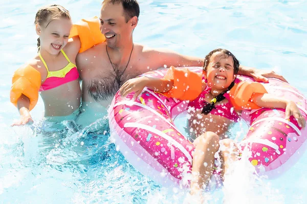 stock image father teaching his daughter to swim, lifestyle concept.