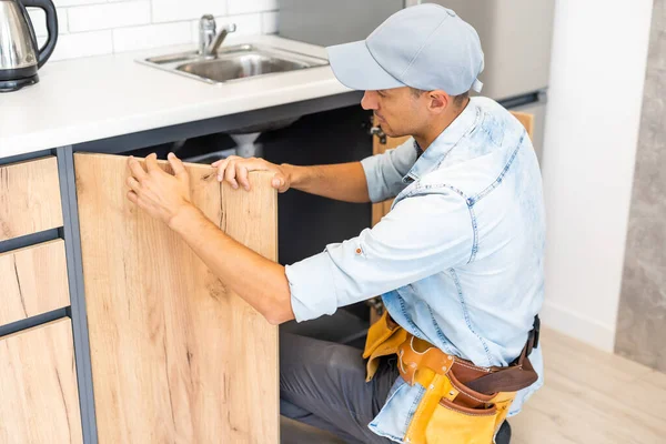 Craftsman carpenter at kitchen cabinet installation service work — Stock Photo, Image