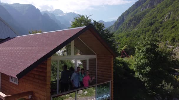 Family on wooden cottage porch on mountain hill top and sunshine. theth national park — ストック動画