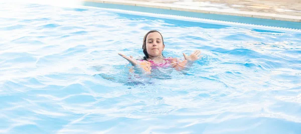 Petite fille s'amuser dans la piscine — Photo