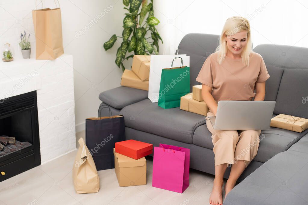 woman shopaholic buy bags bargains use computer credit card to pay easy adore her purchases in comfort house indoors