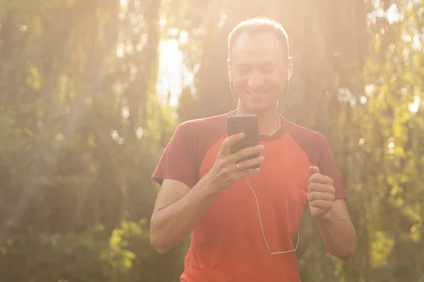 Man running in park at autumn morning. Healthy lifestyle concept