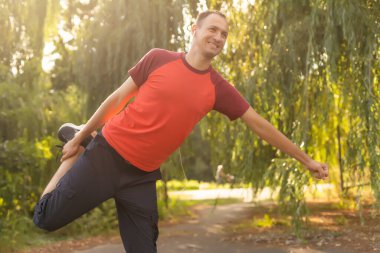 Stretching after jogging. happy man after jogging.