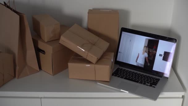 Craft paper bags and cardboards blank box presented on table, laptop — Wideo stockowe