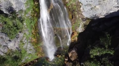 Arnavutluk 'un dağlarındaki Theth köyü yakınlarındaki güzel Theth şelalesi. Yavaş çekimde ormana çağlayan heybetli şelale, lanetli dağlar, Arnavutluk
